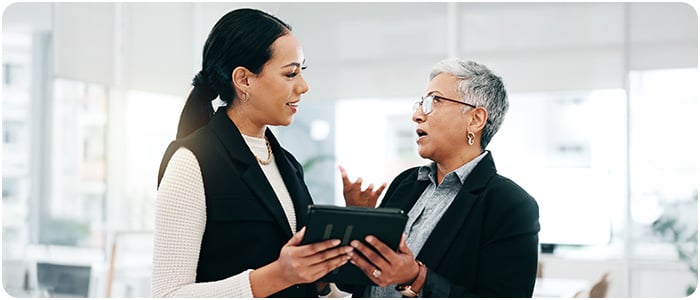 Duas mulheres conversando em ambiente de trabalho